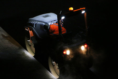 Road repair works at night. Modern machines for the repair and paving of new asphalt.の写真素材