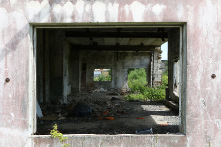 View from the window from the street to the ruined room. Ruined room in an old building.