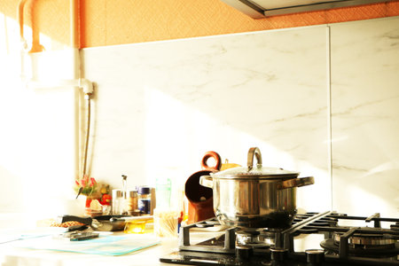 Mess on the kitchen table. A saucepan on the gas stove and a mess on the table.