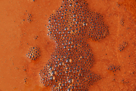 Orange and black bubbles in water close-up. Abstract background.の写真素材