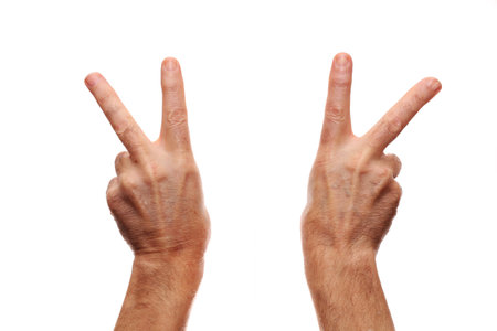 Gesture of victory - two fingers on the hand are stretched to the topの写真素材