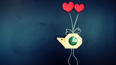 snail compass was tie by red heart shape balloons with wire draw by white chalk on shiny blackboard....
