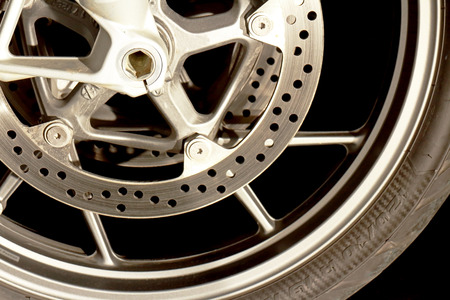 Motorcycle Disc Break and Rim Closeup Image With Black Background
