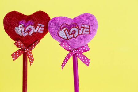 Pink and red hearts on yellow texture background, valentineの写真素材