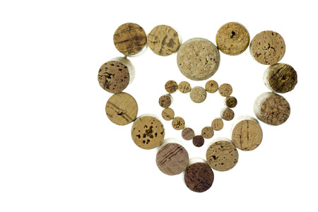 Wine corks form a heart shape image isolated on white backgroundの写真素材
