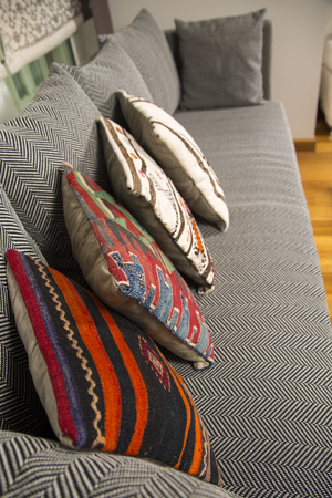 Herringbone sofa with traditional Turkish handmade colorful natural fabric pillowsの写真素材
