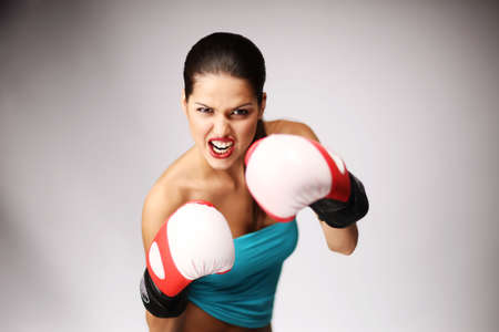 Young sporty woman wiht boxing gloves. Shallow depth-of-field.