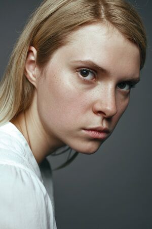 portrait of a beautiful blonde in the studio without makeupの写真素材