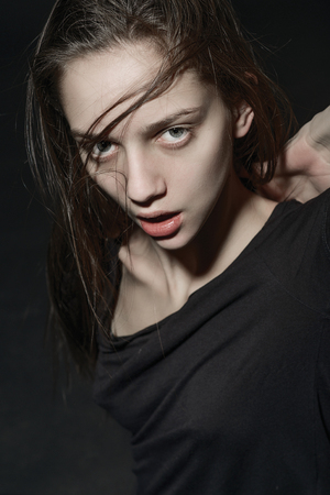 beautiful young woman portrait with long hair in motion, studio shotの写真素材