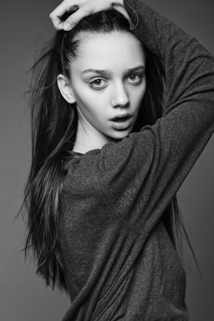 Portrait of a beautiful teenager girl with long hair in studioの写真素材