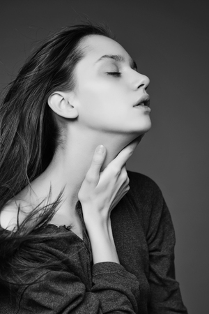 Portrait of a beautiful teenager girl with long hair in studioの写真素材