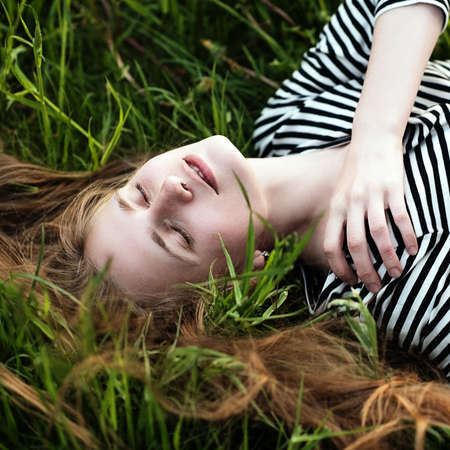 beautiful girl relaxing on a meadow