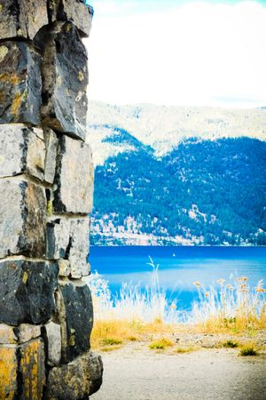 small white sail on the lake between two coasts 1の写真素材