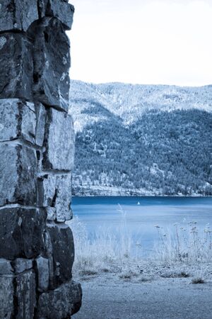 small white sail on the lake between two coasts 2の写真素材