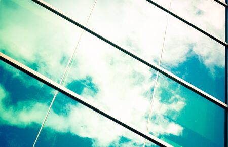 blue sky and white clouds reflected in big windowsの写真素材