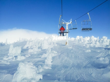 Beautiful sunny day on mountain top, smooth snowy hills and snow surface, clear and blue sky, cold windy day on glacier, winterの写真素材