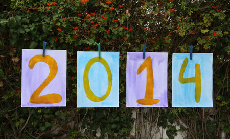 Year 2014 painted in different colors on paper A4 format