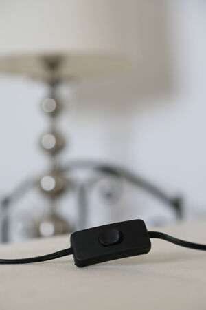 switch of a night light with nightlight in the background