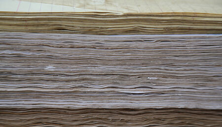 Distressed pages in coffee are compacted, compressed in single-sheet stationery  Background