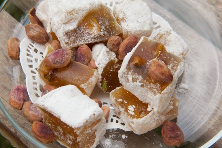 Turkish delight with pistachio seeds on the glass plate. Close up. Top viewの写真素材