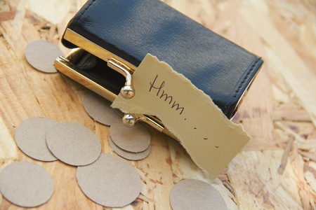 Interjection Hmm.... on the piece of paper placed close to an empty small wallet and faked coins