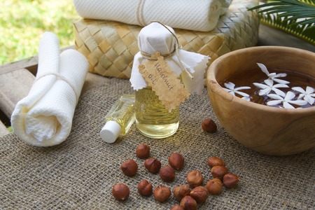 A bottle of hazelnut oil. Hazelnuts in the backgroundの写真素材
