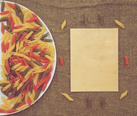Raw three-colored Italian pasta. Free space for a text.Backgroundの写真素材