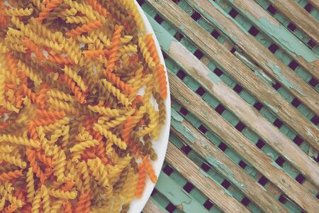 Raw three-colored Italian pasta. Background.Vintageの写真素材