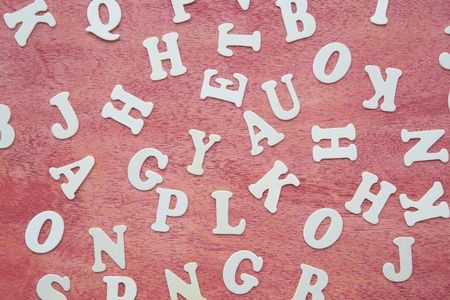 Wooden letters on a red wooden surface - background.の写真素材