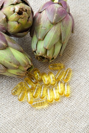 Capsules with artichoke oil on a sackclothの写真素材