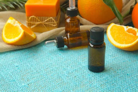 A dropper bottle of sweet orange essential oil. Oranges in the backgroundの写真素材