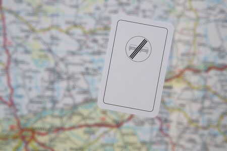 A card with the image of prohibitary traffic  sign No passing on the road map