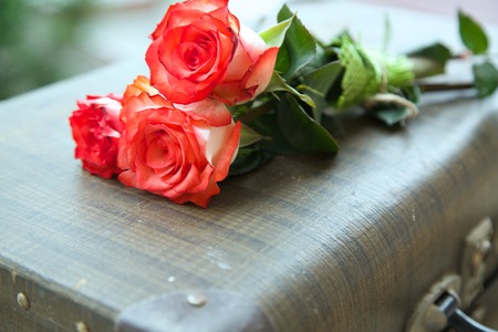 A bunch of roses on an old vintage caseの写真素材