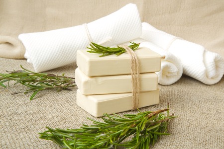 Soap bars with rosemary essential oil.Rosemary twigs in the backgroundの写真素材