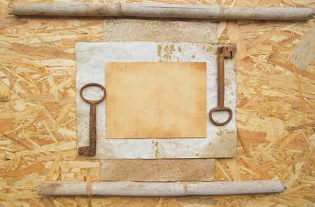 Vintage background: two big rusted keys,old  paper on a wooden surfaceの写真素材