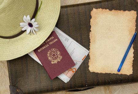 Summer travel hat,flower,old suitcase,Italian passport,map and travel checklist with free space for a text.の写真素材