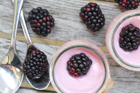 Blackberries homemade yogurt in the glass cups. Closeupの写真素材