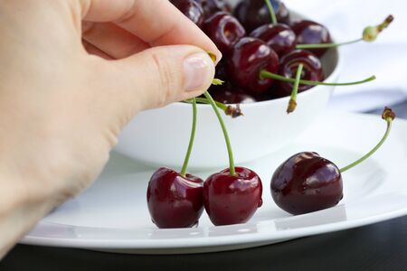 Sweet cherries in a white plate. Closeupの写真素材