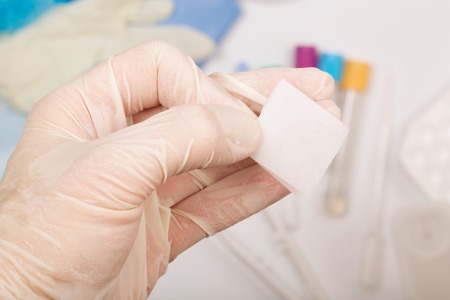 Alcohol wipe in the hand of a lab technician. Closeupの写真素材