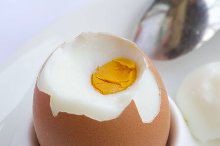 Boiled egg on a white egg holder. Closeupの写真素材