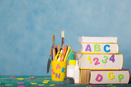 Back to school stationery is on the table.Blue sky coloured backgroundの写真素材