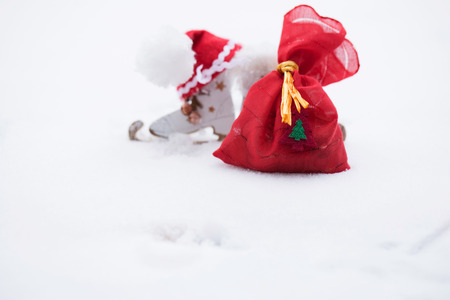Winter holidays background:  wooden made skates and Santa Claus hat. Closeup