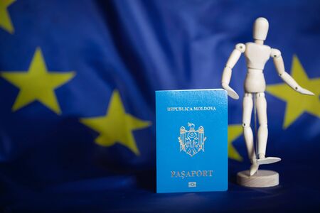 Moldovan pass and wooden dummy figurine on the European flag. Closeupの写真素材
