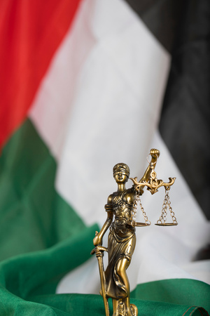 Statue of Themis. Closeup. Flag of the United Arab Emirates in the backgroundの写真素材