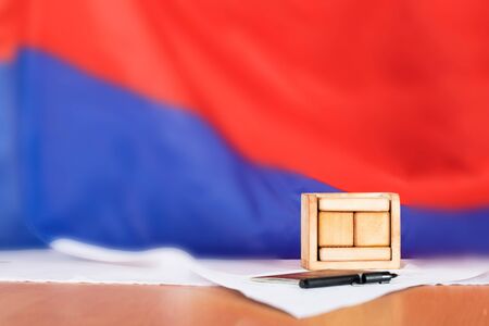 Wooden calendar with free text in front of Russian flag. Russian pass, pen and ballot paper in the background. の写真素材