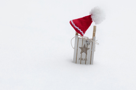 Winter holidays background:  Santa Claus hat on a wooden made sleigh. Closeupの写真素材