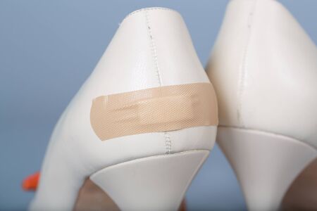 Adhesive bandage attached to summer high heels. Closeupの写真素材