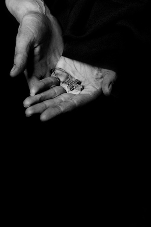 Wooden handmade cross in the palm of a peasant woman. Closeupの写真素材