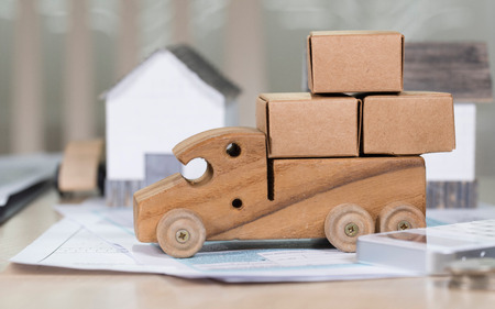Small wooden truck loaded with carton boxes for moving. Closeupの写真素材