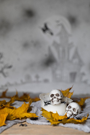 Skull on an old used thick candle. Scary Halloween background. Closeupの写真素材